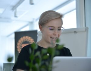 Kuvassa nainen työskentelee tietokoneella.